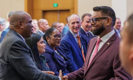 Prof. Benedict Oramah, President and Chairman of the Board of Directors of African Export-Import Bank (Afreximbank) exchanges pleasantries with H.E. Mohamed Irfaan Ali, President of Guyana (right) during the Guyana Energy Conference